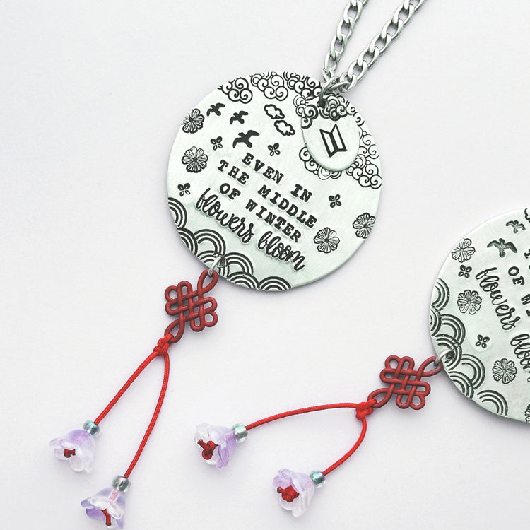 Car charm with arirang lyrics with red lucky knot and purple flowers