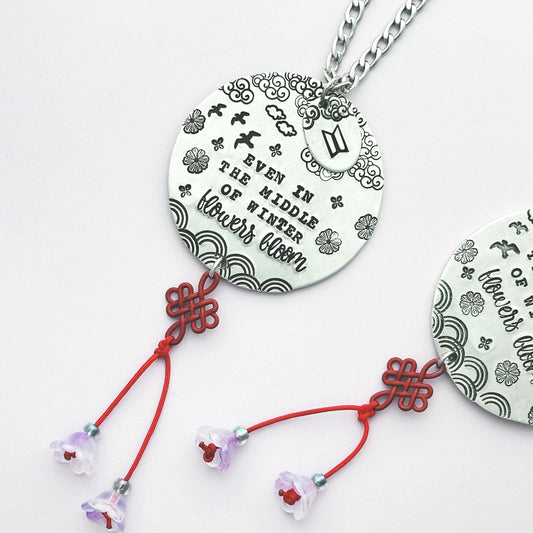 Car charm with arirang lyrics with red lucky knot and purple flowers